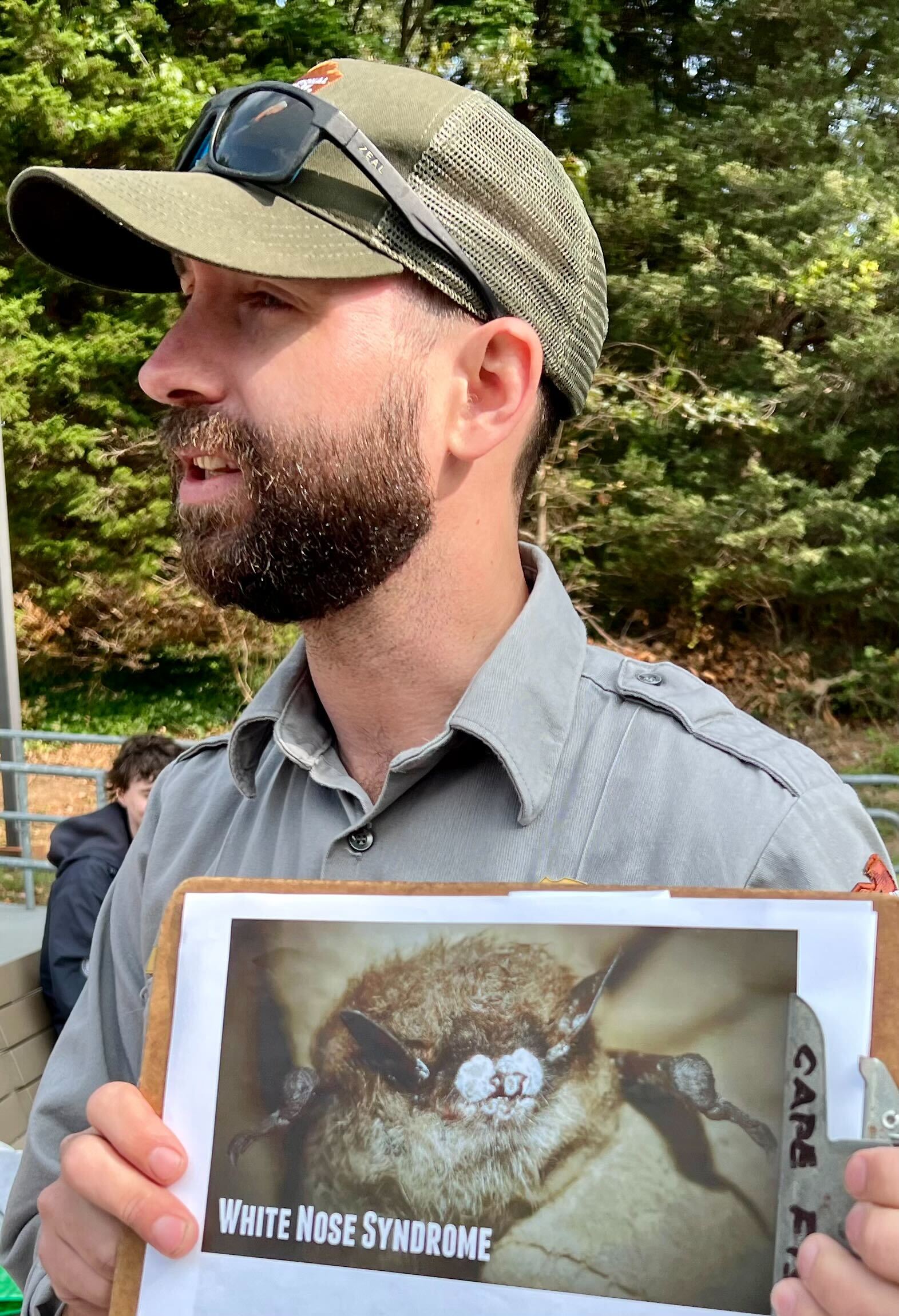 Michael Raymonds with the National Park Service shows volunteers a photo of an endangered Little Brown Bat suffering from White Nose Syndrome.