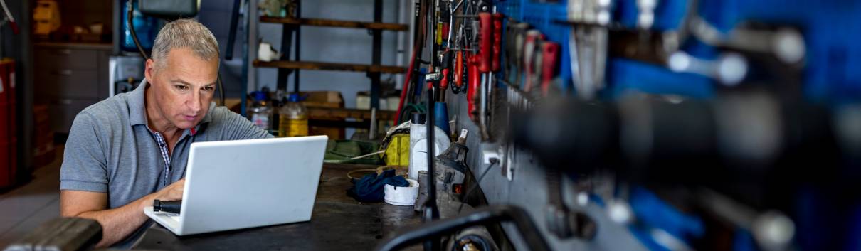 Man in workshop on his laptop