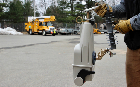 Eversource line worker holding a smart fuse