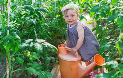 little-girl-watering-garden