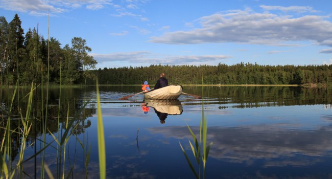 Father and son boating in a lake