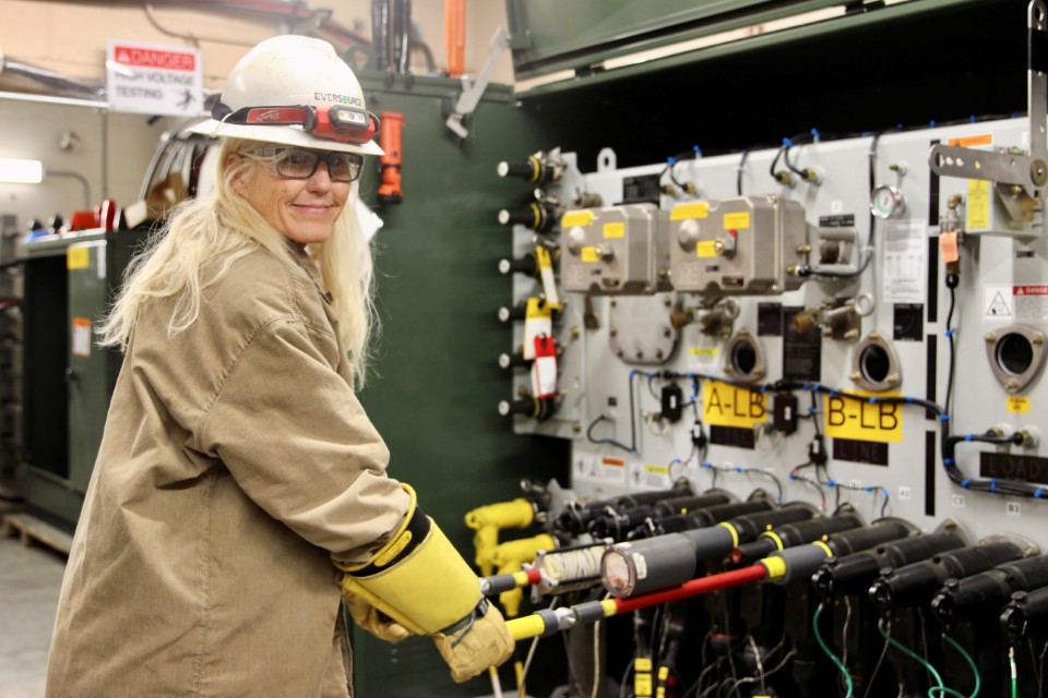 Tammy Pease in a hard hat using training equipment