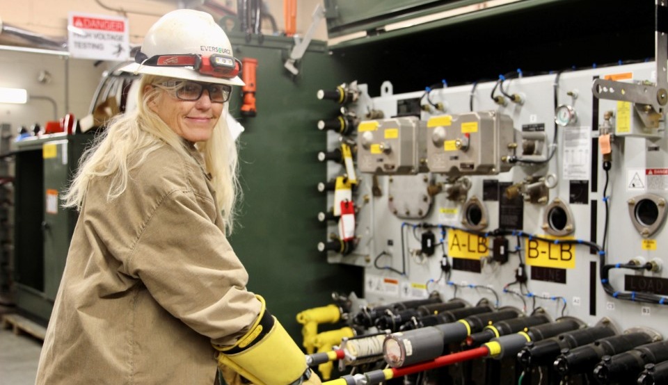 Tammy Pease in a hard hat using training equipment