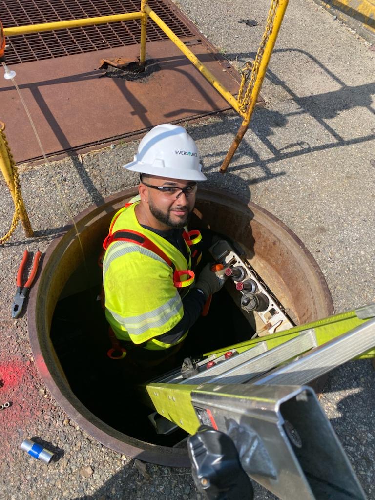 Marque Hackett working in a manhole.