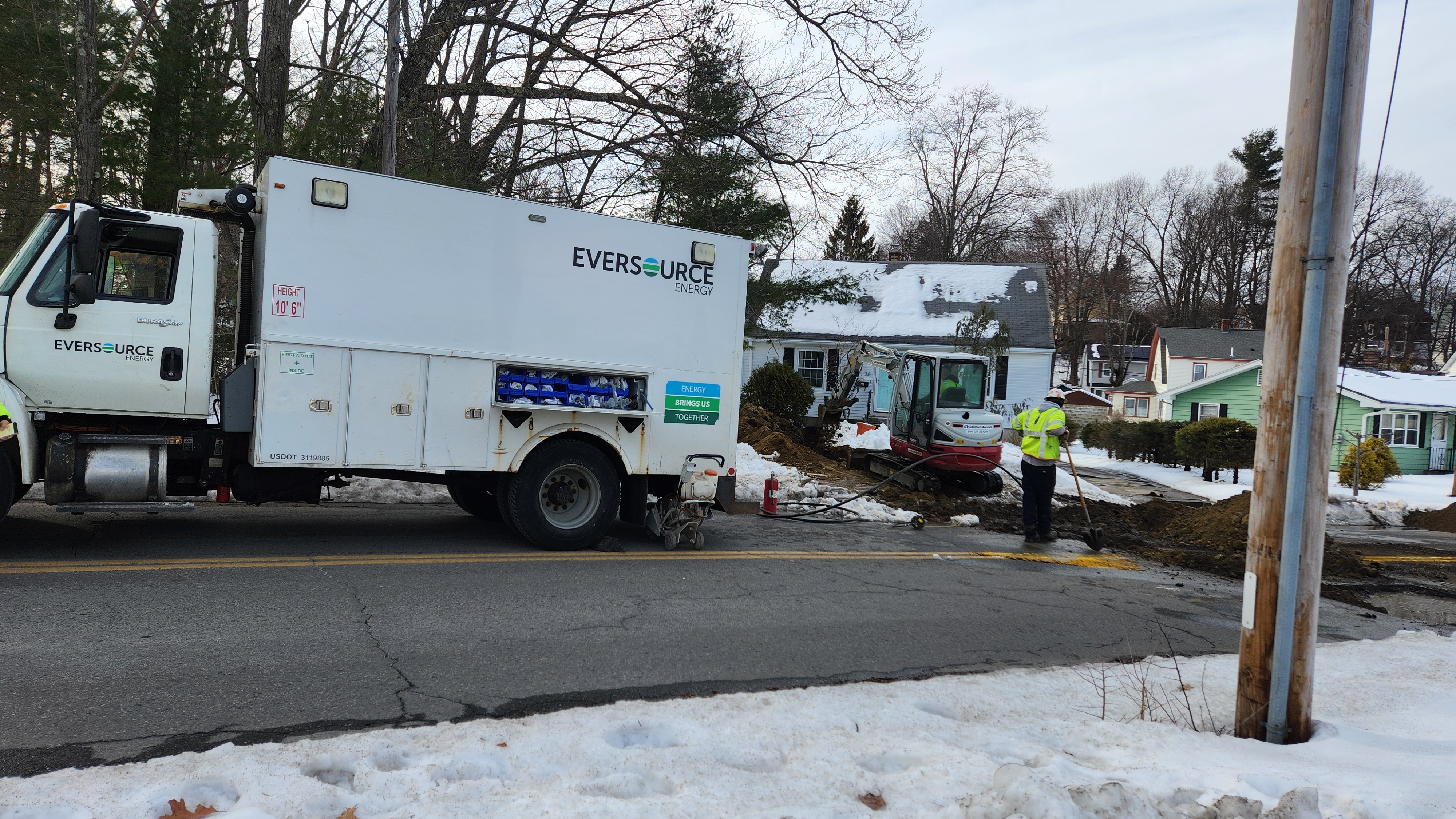 An Eversource gas crew works on a street during the winter