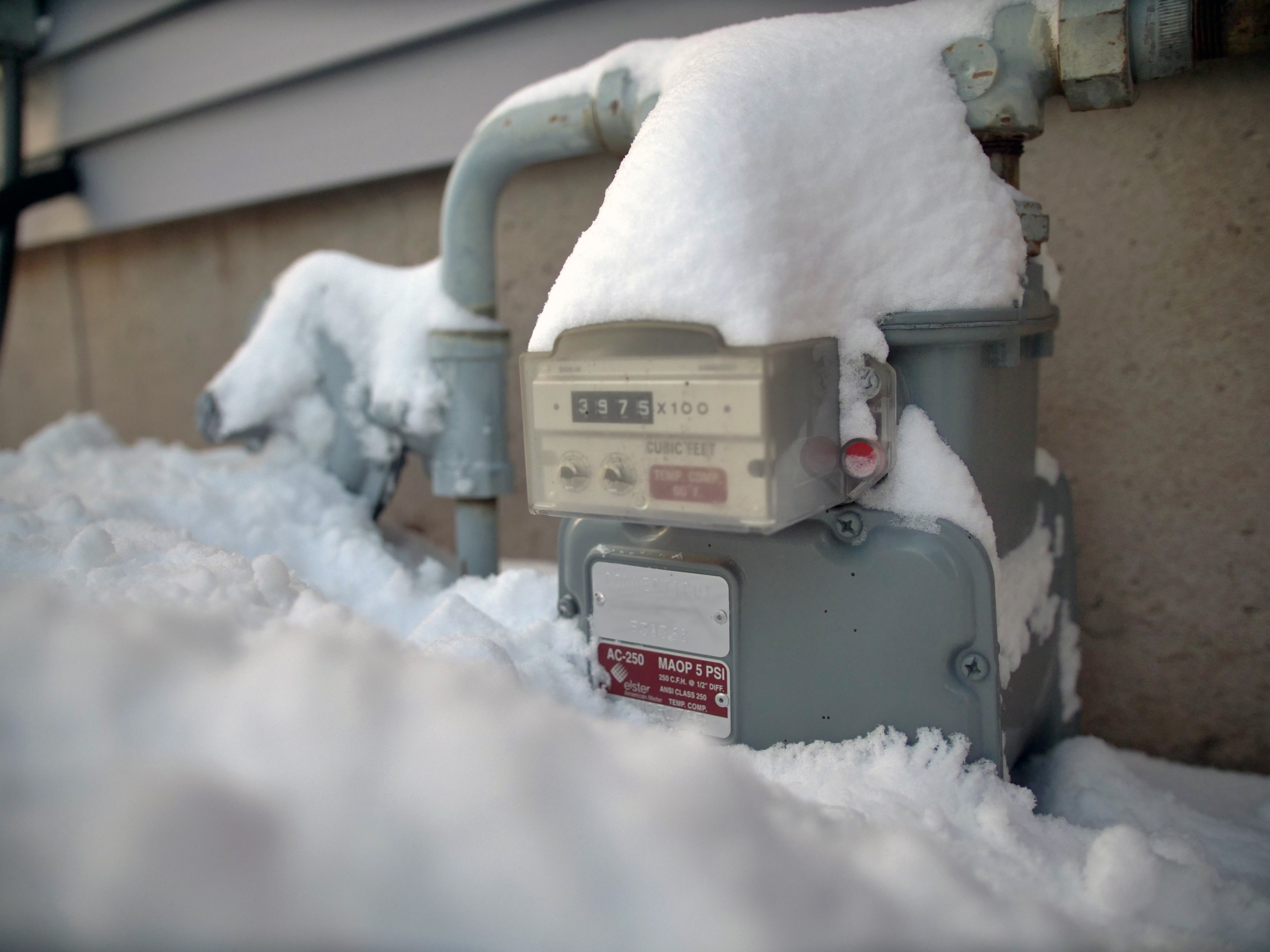 A gas meter with snow that needs to be cleared