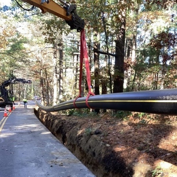 A new pipe being lowered into the ground